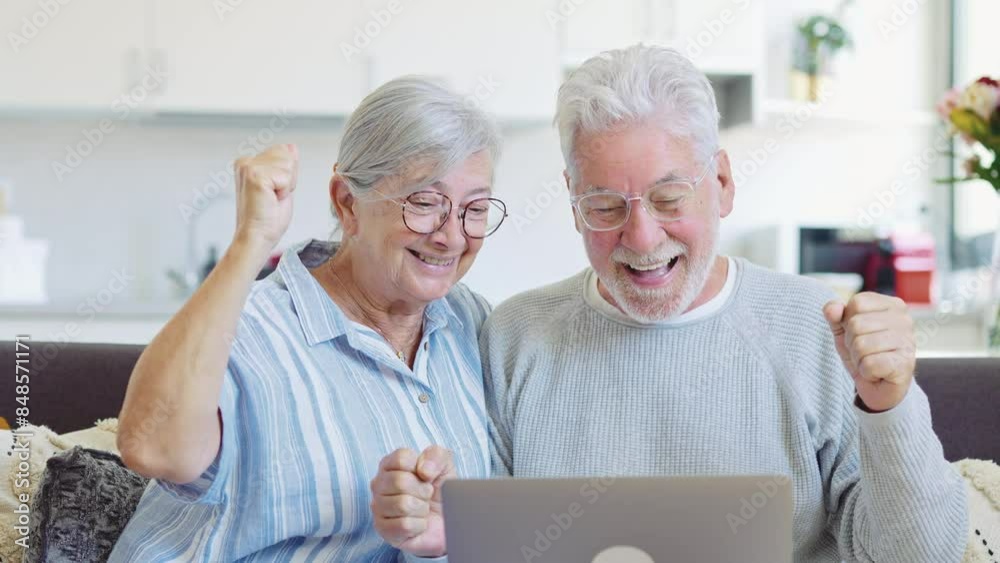 Excited senior mature couple surprised by good unbelievable news, unexpected win, huge shopping sale offer on website, astonished older middle aged family looking at computer screen feeling amazed
