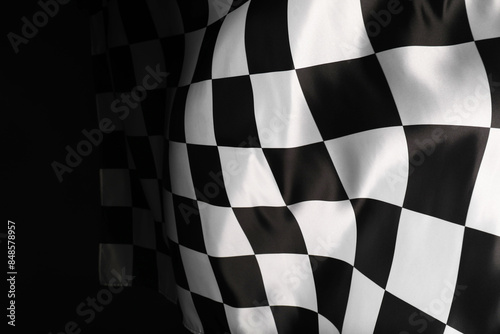 Checkered flag on black background, space for text