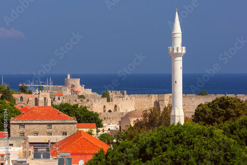 Panoramic view of Rhodes city, featuring a mosque minaret, castle, and the Aegean Sea in Greece