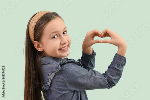 Cute little girl making hea...