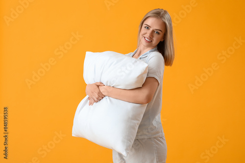 Happy young woman in pajama...