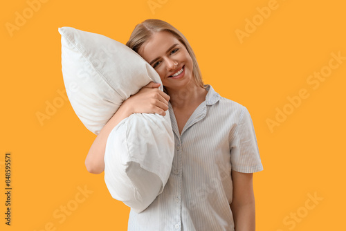 Happy young woman in pajama...