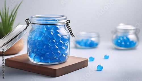 blue orbeez in a glass jar on a light background selective focus photo