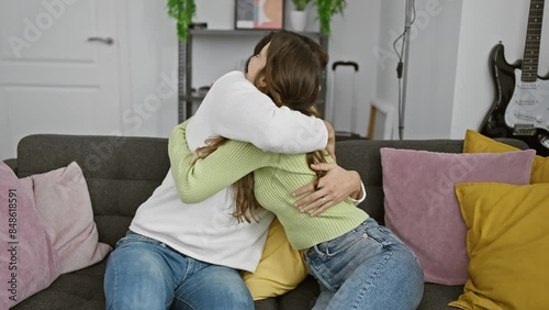 Woman and man embracing lovingly on a home couch, reflecting a warm, affectionate relationship amid cozy decor.