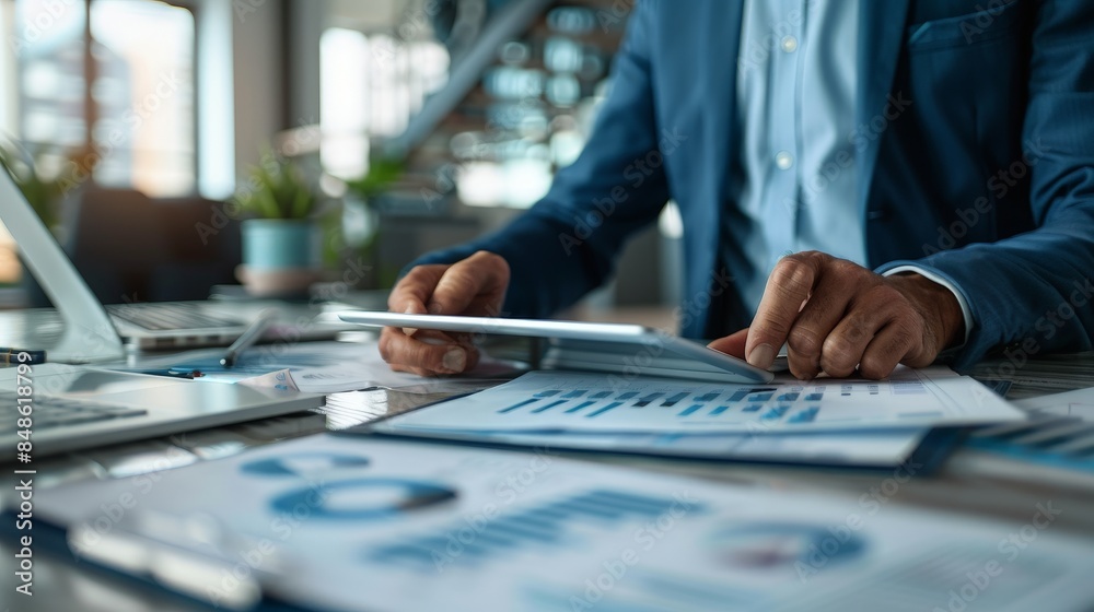 Business Professional Analyzing Financial Reports with Digital Tablet in Modern Office Environment Business Professional Analyzing Financial Reports with Digital Tablet in Modern Office Environment