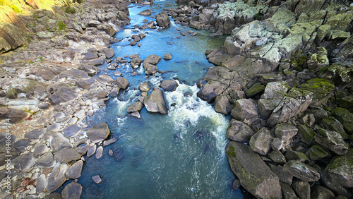 The South Esk River, shallow in its course, cascades over a bed of moss-covered igneous dolerite rock, creating a sequence of cataracts. photo