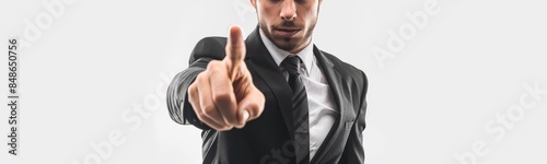 A businessman in a suit points his finger forward.