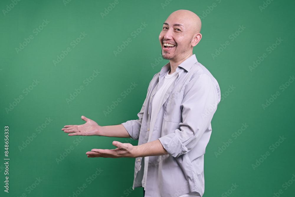 Side View Of A Smiling Bald Man With Open Arms Posing Side View Of A Smiling Bald Man With Open Arms Posing