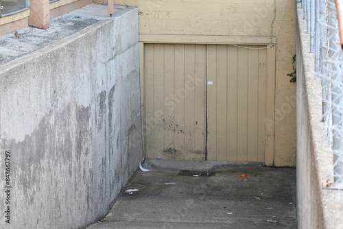 Basement garage door down cement ramp.