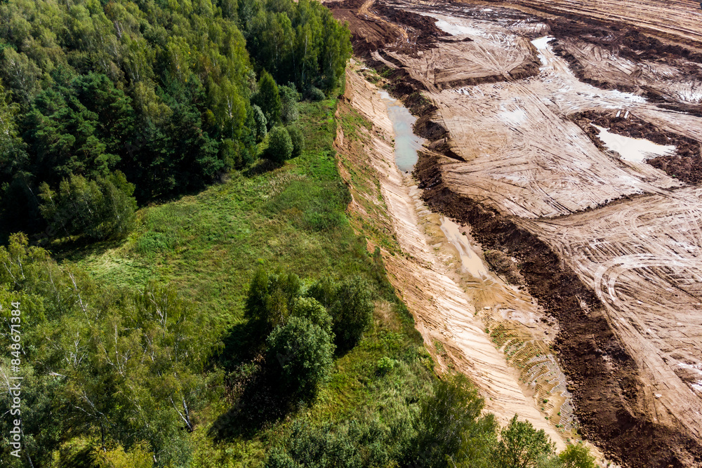 Sand and gravel quarry close to the forest, aerial view Sand and gravel quarry close to the forest, aerial view