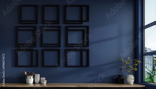 A minimalist kitchen with a deep blue wall, featuring six empty black frames in a honeycomb pattern. photo