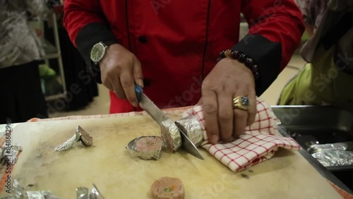 People Cut Lupis meat thinly on the table photo