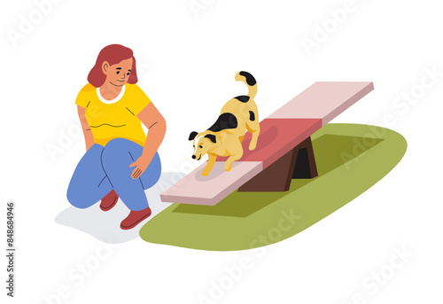 Woman Training Dog On Agility Seesaw