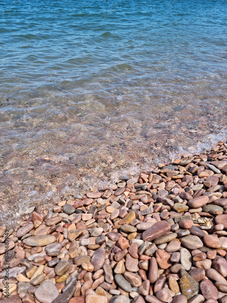It is a beach with round pebbles.
It is a beach with round pebbles.