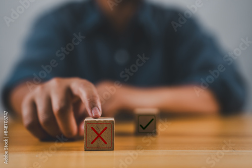 Hand push red, Red Cross mark to choose cancellation item, Approve and reject business and document concept.
