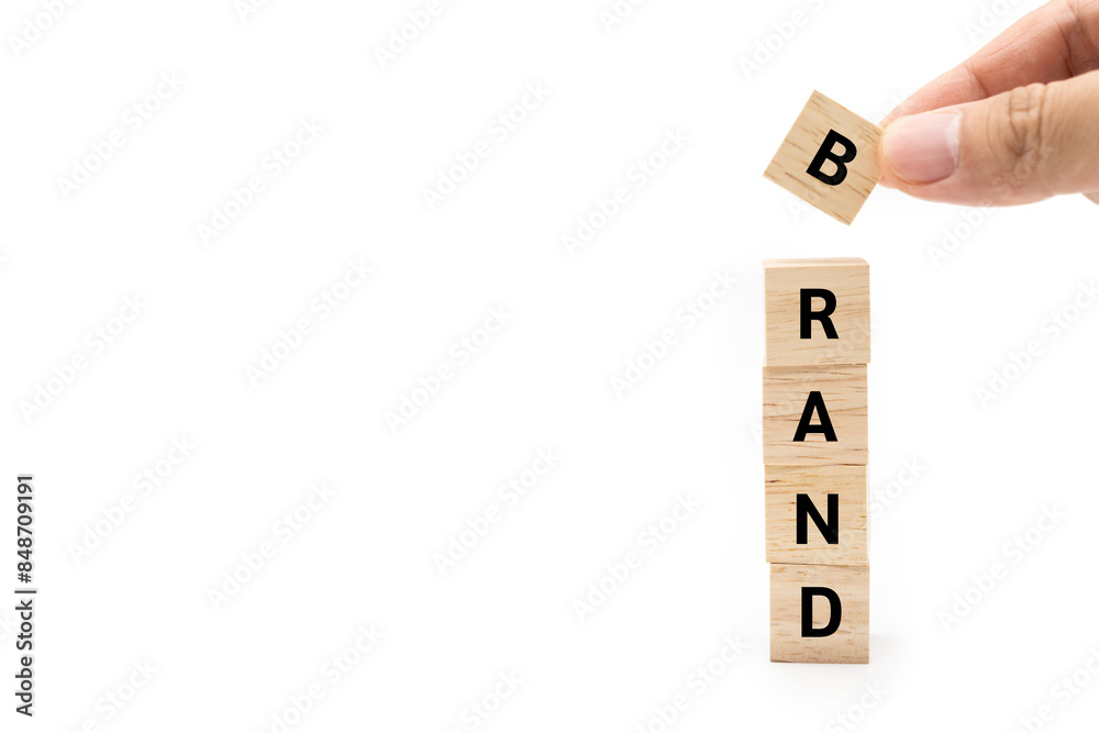 Hand putting wood cube block with BRAND text isolated on white background. Build your Brand. Brand building, success, business. Hand putting wood cube block with BRAND text isolated on white background. Build your Brand. Brand building, success, business.