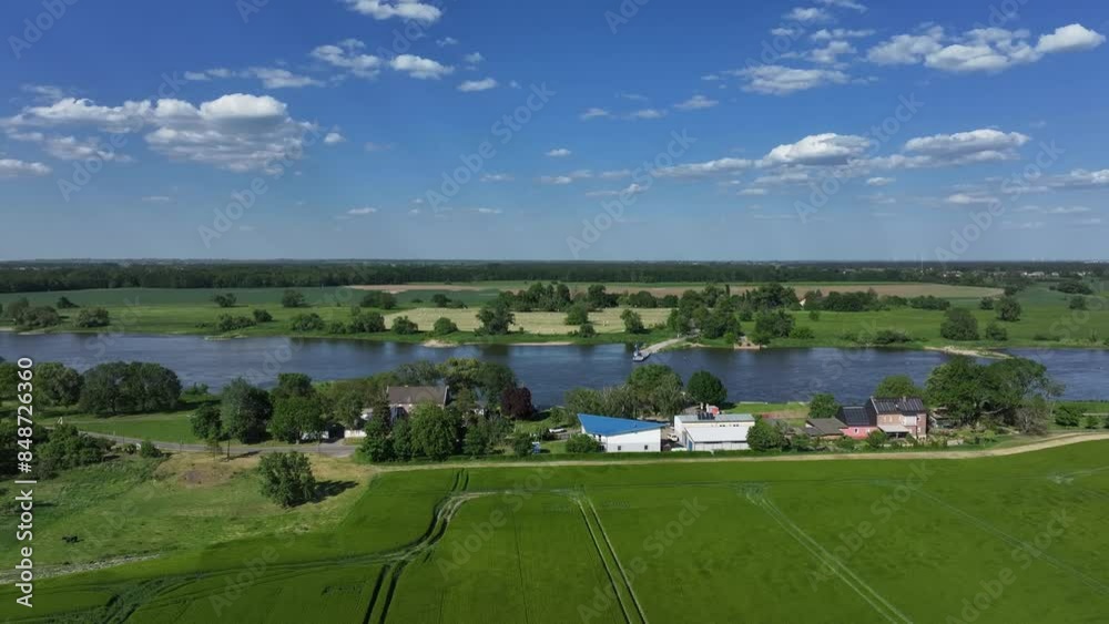 Elbe near Barby, Saxony-Anhalt. Flight from left to right. River in the center of the picture. Meadows and fields on both sides. Buildings in the foreground. Ferry dock in the center Elbe near Barby, Saxony-Anhalt. Flight from left to right. River in the center of the picture. Meadows and fields on both sides. Buildings in the foreground. Ferry dock in the center
