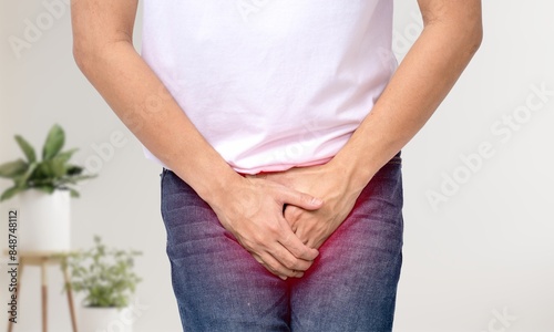 Man hold hand in front of private parts feeling discomfort from disease and inflammation pain in prostate Venereal, testicular bladder problems, premature ejaculation, prostate cancer.