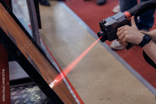 Technology machine laser beam for remove rust from metal. Cleaning iron surface before welding