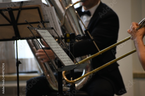 Closeup of musicians following a music score. Orchestra musical instrument closeup.
