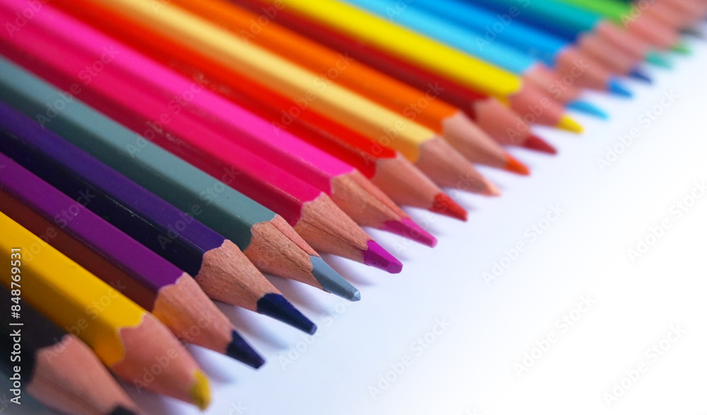 A diagonal arrangement of sharpened colored pencils with the tips facing the viewer. A diagonal arrangement of sharpened colored pencils with the tips facing the viewer.