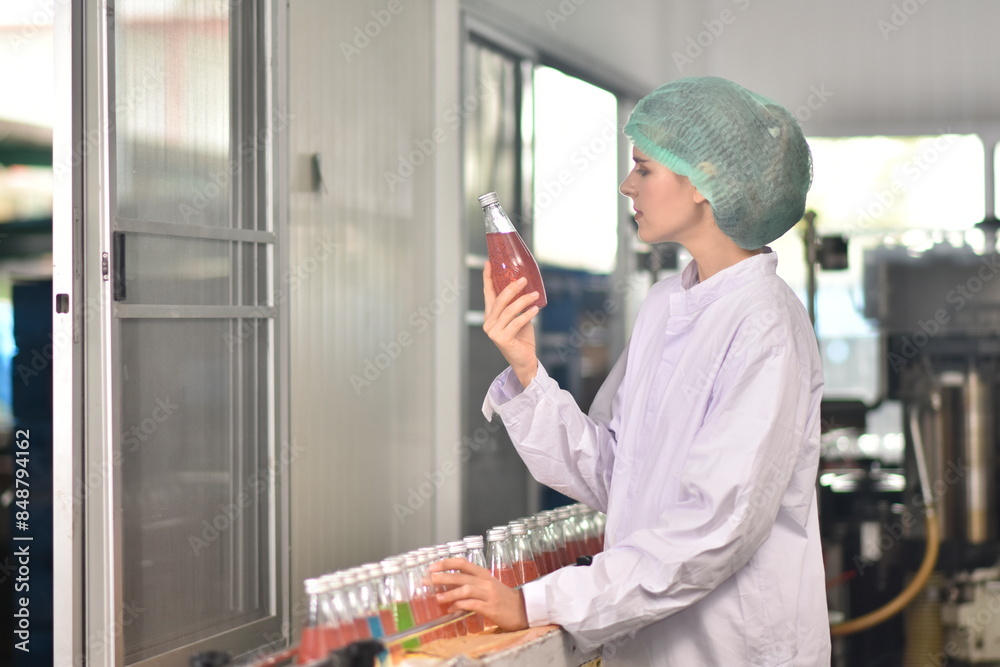 QC manager inspecting the quality of a beverage product in the production process QC manager inspecting the quality of a beverage product in the production process