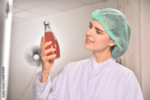 QC manager inspecting the quality of a beverage product in the production process photo