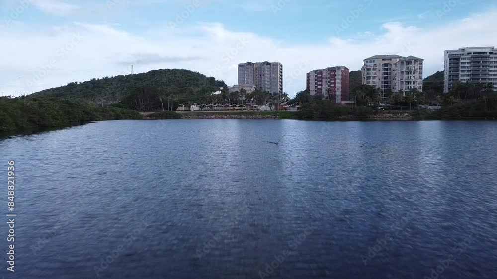 Lake at El Morro Lagoon with luxury residence houses in Venezuela. Aerial approaching shot. Playa Caracola at Isla de Margarita. Lake at El Morro Lagoon with luxury residence houses in Venezuela. Aerial approaching shot. Playa Caracola at Isla de Margarita.