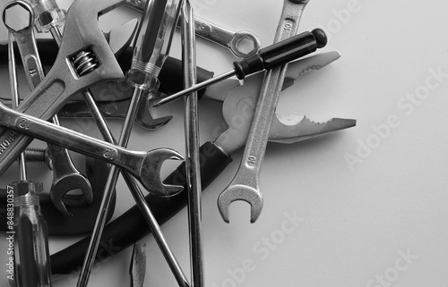 Black And White Tools And Equipment Stock Image. Pliers, Wrenches, Spanners, Screwdrivers, Clamps And Hex Keys Disorderly Scattered Closeup Angle View photo