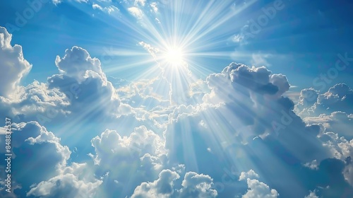 Fototapeta Naklejka Na Ścianę i Meble -  Blue sky with soft clouds and the sun peeping behind a white cloud