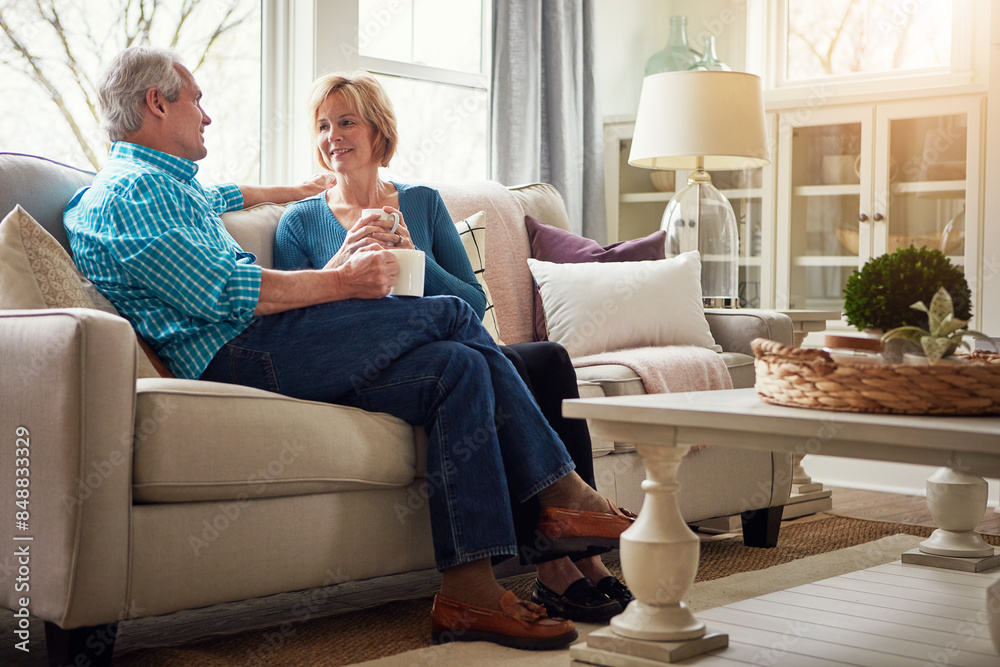 Senior couple, coffee and smile on sofa in conversation, relax or happy memory in home living room. Old man, elderly woman and chat for bonding with tea, love or story in retirement on couch in house Senior couple, coffee and smile on sofa in conversation, relax or happy memory in home living room. Old man, elderly woman and chat for bonding with tea, love or story in retirement on couch in house
