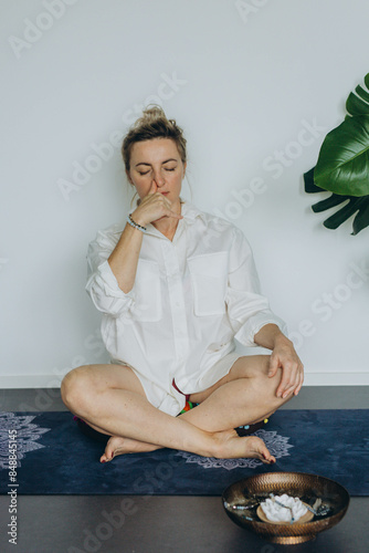 Attractive young woman practing yoga stretching yoga at home.  photo