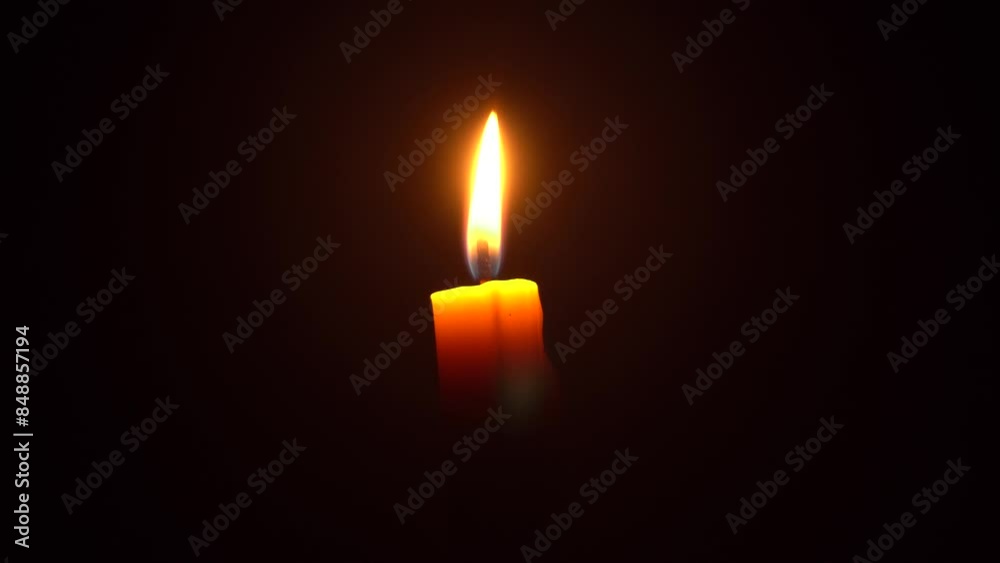 Burning of candles placed at night. A single candle burning Isolated with dark background.