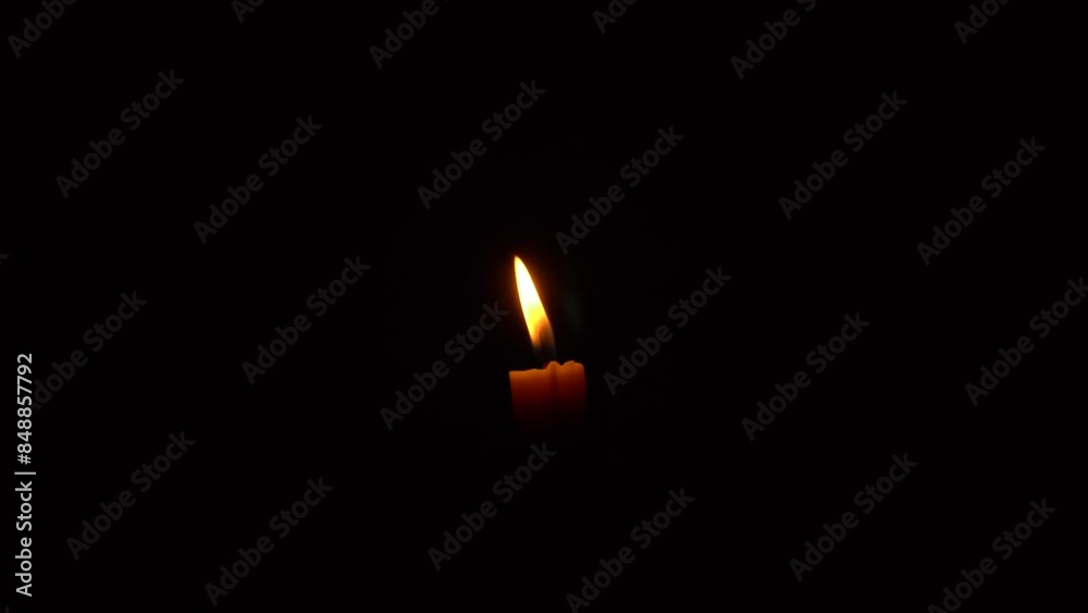 Burning of candles placed at night. A single candle burning Isolated with dark background. Burning of candles placed at night. A single candle burning Isolated with dark background.