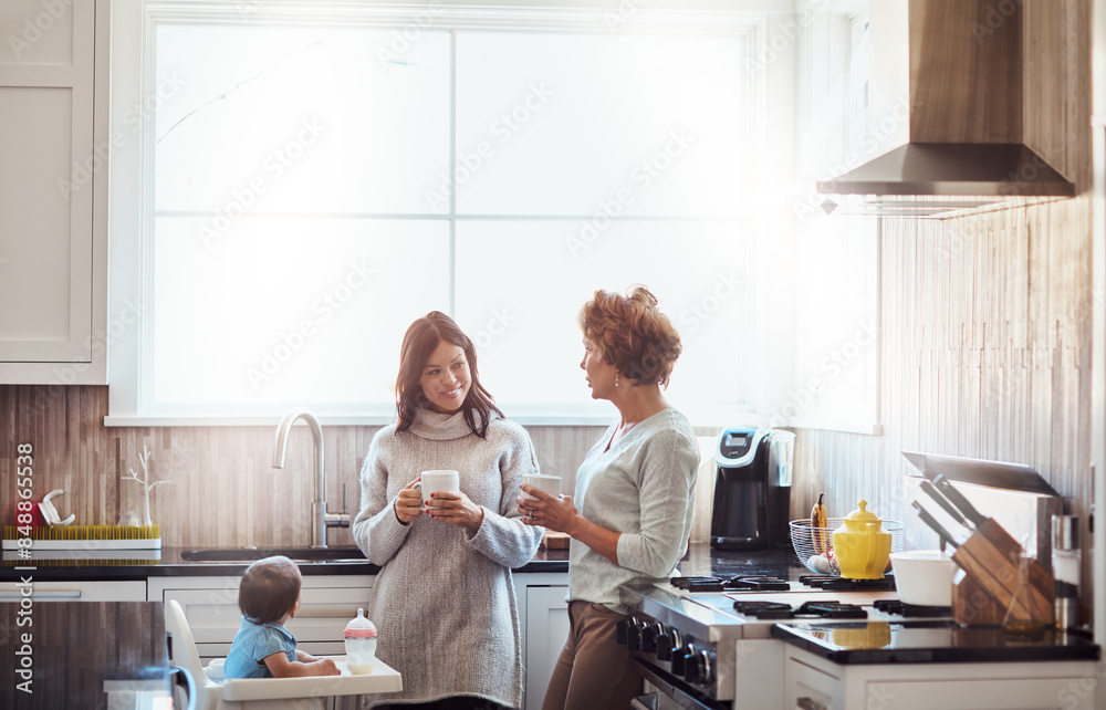 Grandmother, mom and child in kitchen for love, support and coffee in family home. Women, talking and together in house for childcare, security and protection with toddler for visit or bonding Grandmother, mom and child in kitchen for love, support and coffee in family home. Women, talking and together in house for childcare, security and protection with toddler for visit or bonding