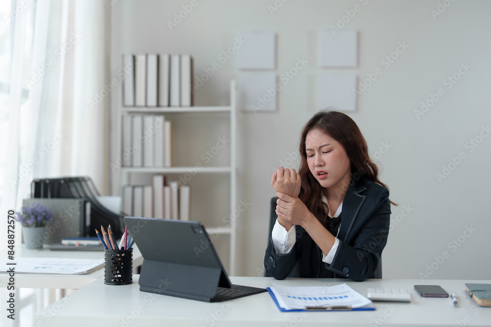 Tired businesswoman having a headache in modern office Creative woman working at a desk Ordinary female office worker Feel body aches while working hard on your laptop computer. Tired businesswoman having a headache in modern office Creative woman working at a desk Ordinary female office worker Feel body aches while working hard on your laptop computer.
