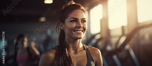 Woman at the gym working out with her trainer in a photo with copy space image photo