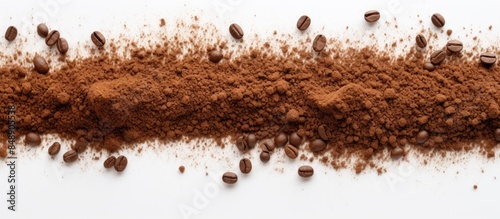 Top down view of ground coffee scattered on a white background with copy space image