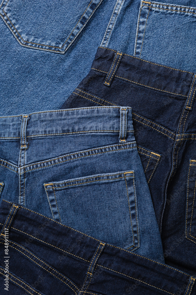 Fototapeta premium Close-up of blue jeans back pockets in various shades of blue denim.