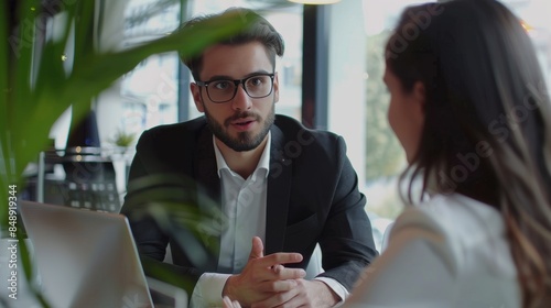 Young specialist sales explains to couple clients in office