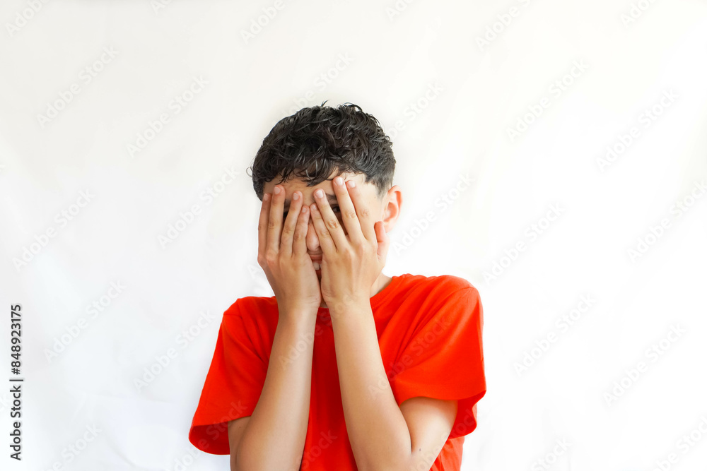 child, preteen, on a white background, with freckles, with a gesture or pose of covering his face with his hands child, preteen, on a white background, with freckles, with a gesture or pose of covering his face with his hands
