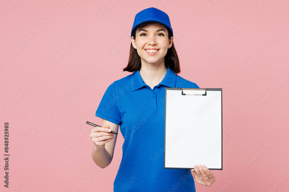 Professional delivery girl employee woman wear blue cap t-shirt uniform workwear work as dealer courier hold give pen clipboard with papers document isolated on plain pink background. Service concept. Professional delivery girl employee woman wear blue cap t-shirt uniform workwear work as dealer courier hold give pen clipboard with papers document isolated on plain pink background. Service concept.