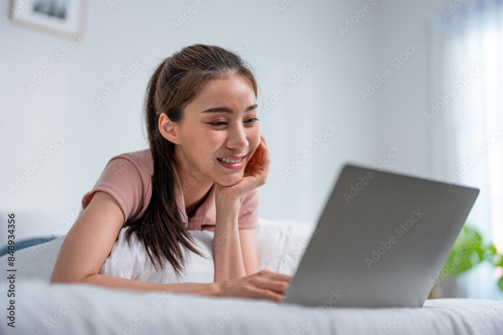Asian attractive woman using laptop chat on bed at home in the morning. Asian attractive woman using laptop chat on bed at home in the morning.