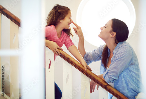 Bild auf Leinwand Funny, child and mother touch nose for love, care and family bonding on stairs in home
