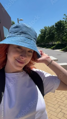 Young woman walking in the street pov. Vertical video