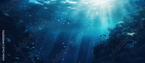 Wallpaper Mural Underwater world in shades of cyan and dark marine blue with ink spreading through water enhanced by light casting circular gradients and depth ideal for copy space image Torontodigital.ca