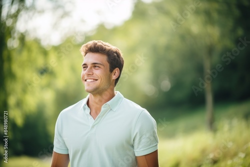 Portrait of a smiling man in his 20s donning a classy polo shirt in solid pastel color wall
