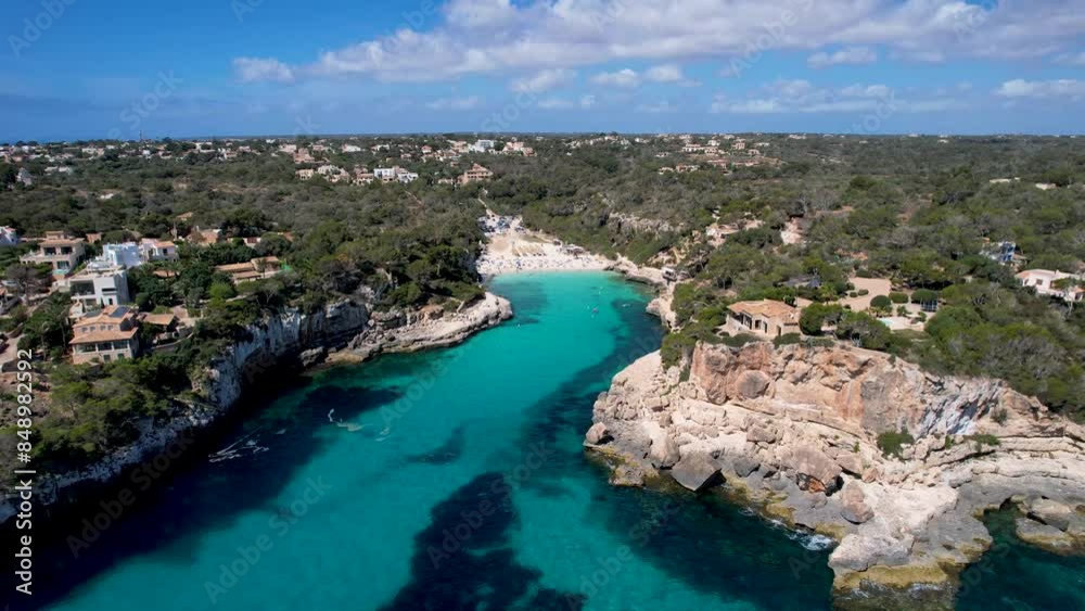 4K Aerial Drone video of a unique rock formation with an arch separated from the cliffs with turquoise clear blue water and beach nearby. Es Pontas, Mallorca 4K Aerial Drone video of a unique rock formation with an arch separated from the cliffs with turquoise clear blue water and beach nearby. Es Pontas, Mallorca