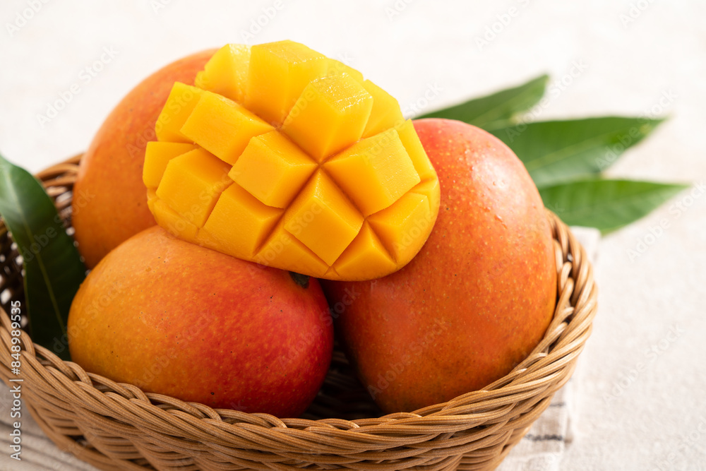 Fresh slice cut juicy mango on gray table background with leaf. Fresh slice cut juicy mango on gray table background with leaf.