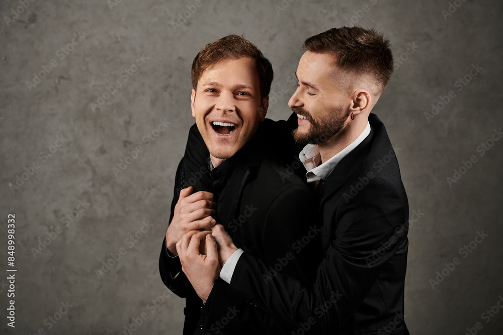 Two men in suits laughing together. Two men in suits laughing together.